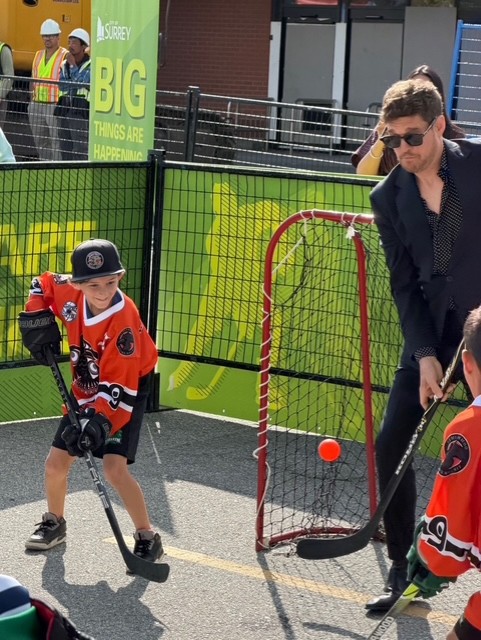 Ravens players take part in a ball hockey game with Mayor Brenda Locke, the Vancouver Giants, and Michael Bublé